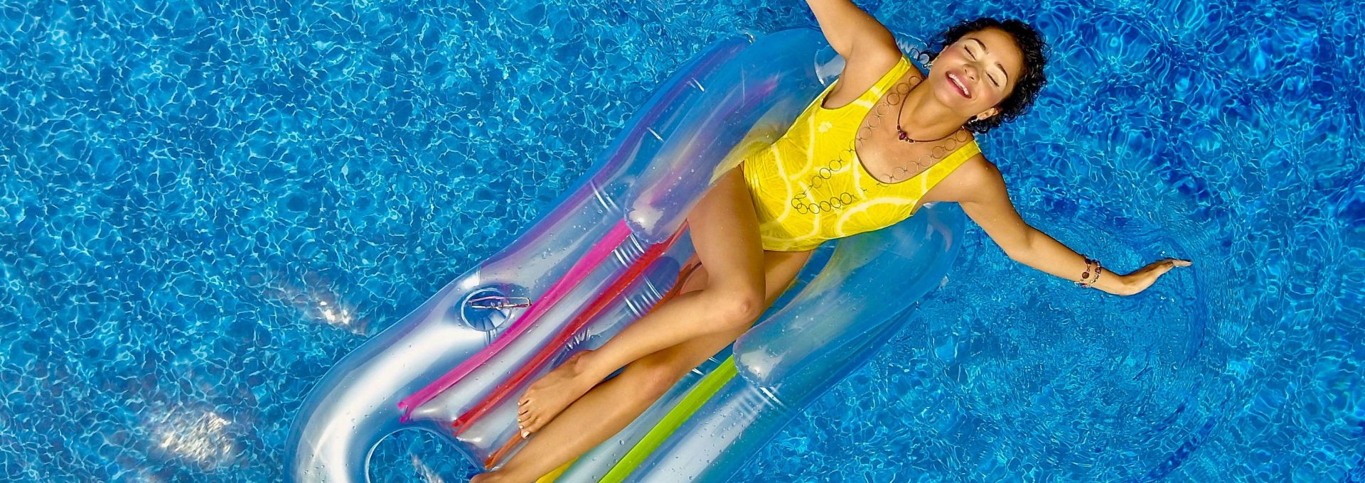 a woman floating on an inflatable raft in a swimming pool at The  Palmer