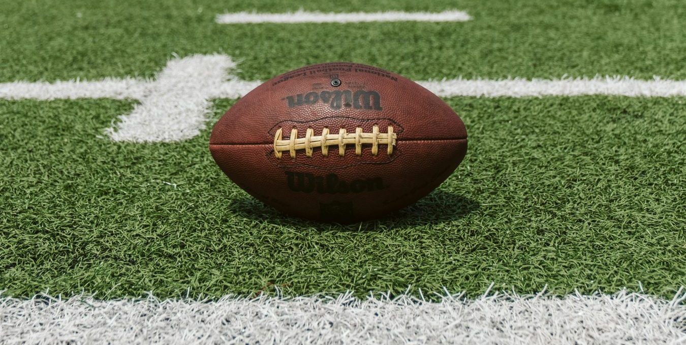 an american football sits on the field at The  Palmer